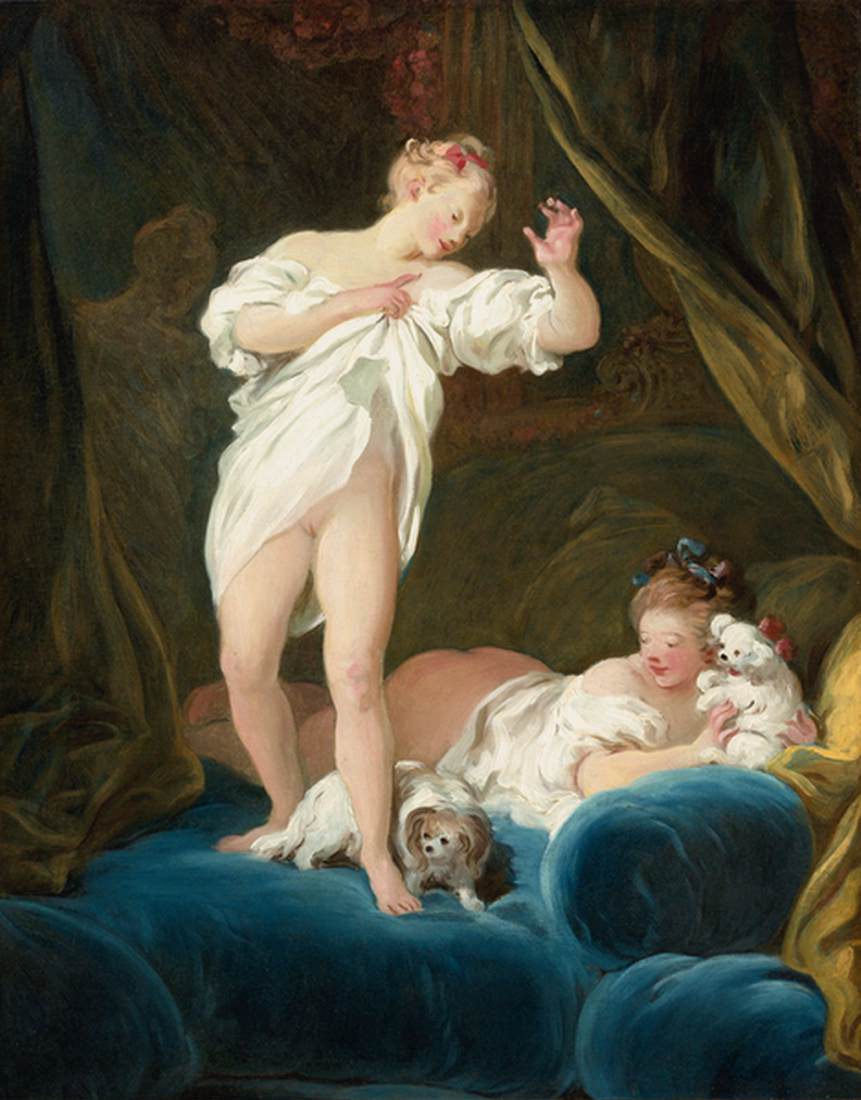 Due ragazze in un letto che giocano con i loro cani