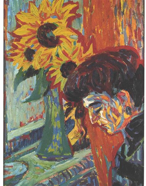 Women's head in front of sunflowers