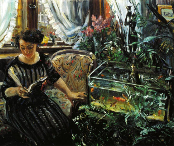 Woman next to a fishbowl with colored fish - 1911