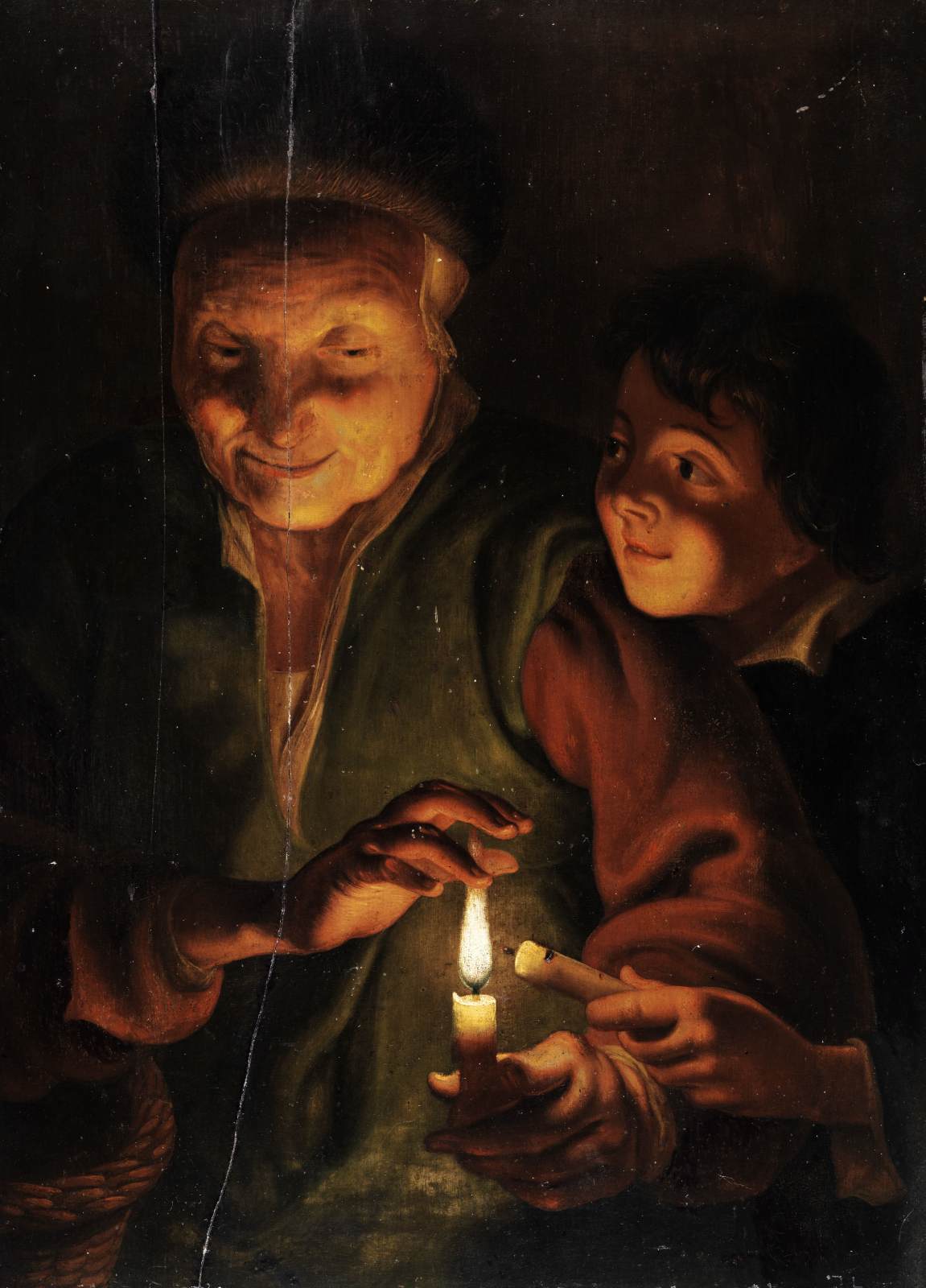 Mulher velha com menino à luz de velas